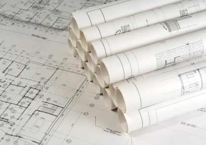 Blueprints printed online and stacked ready for the next review of the job.