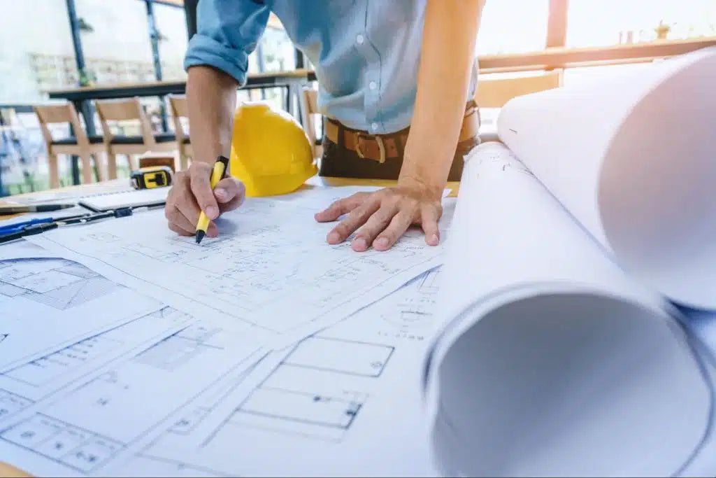 Contractor reviewing blueprints to prepare for jobsite.