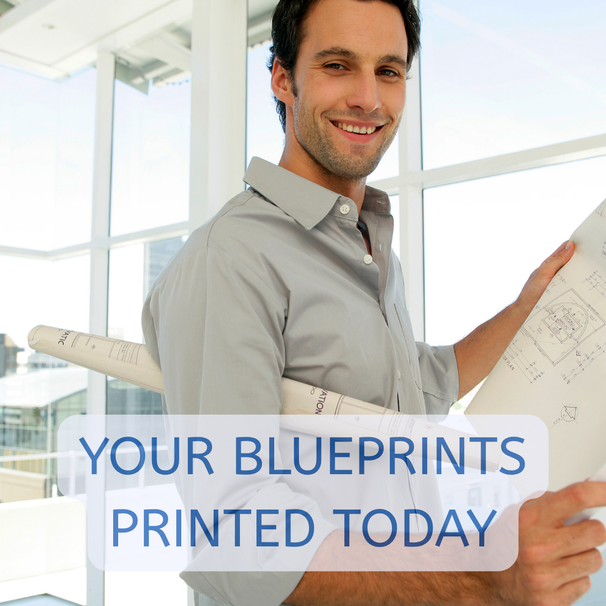 Man holding blueprints he printed online that are 24x36 size printed to scale.