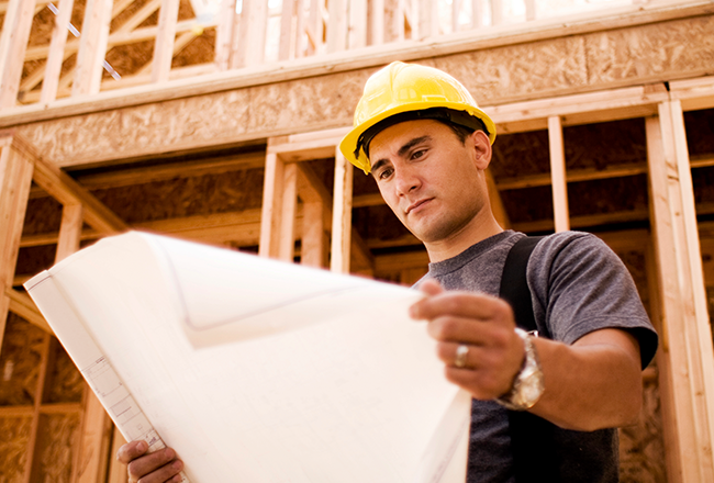 Homebuilder reviewing blueprints printed by Staples.